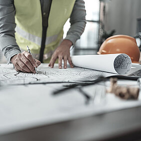 SIKA Construction Site; Man writing on blueprints